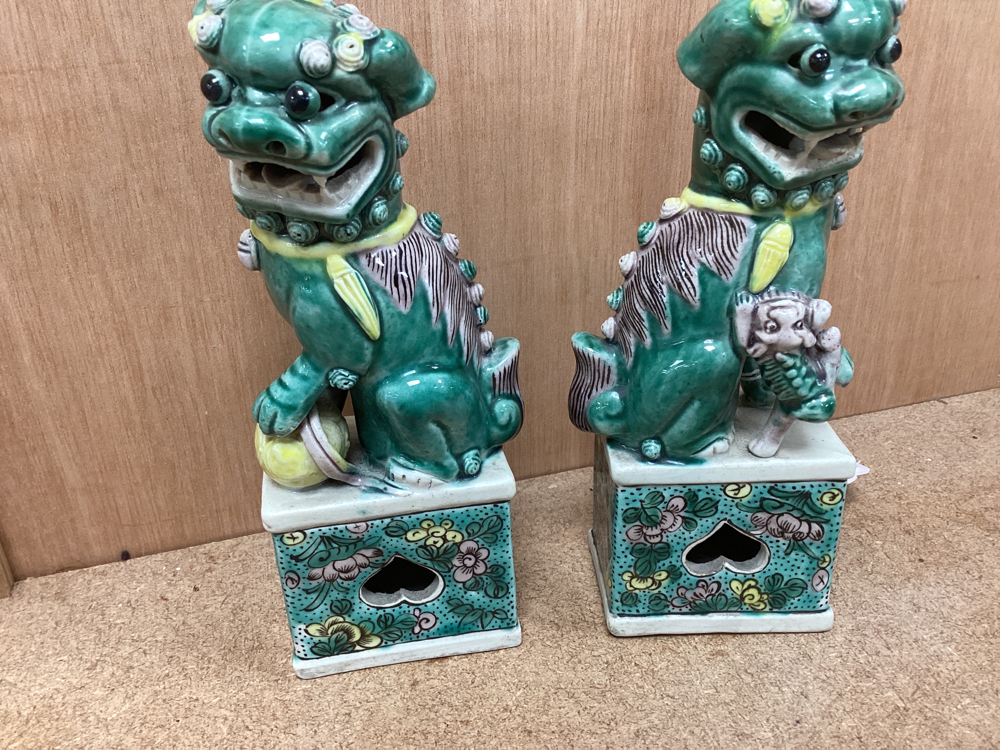 A pair of small early 20th century Chinese figures of Buddhist lions, 15.5cm high